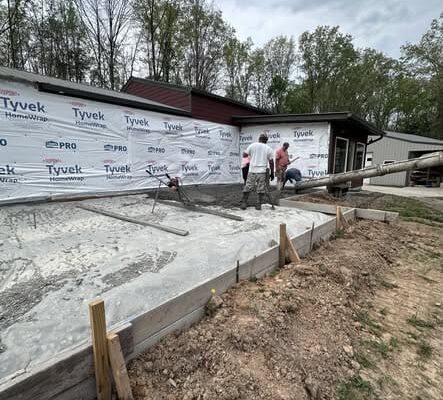 Freshly poured concrete slab in Lyles, TN for a 1,100-square-foot home addition before framing begins.